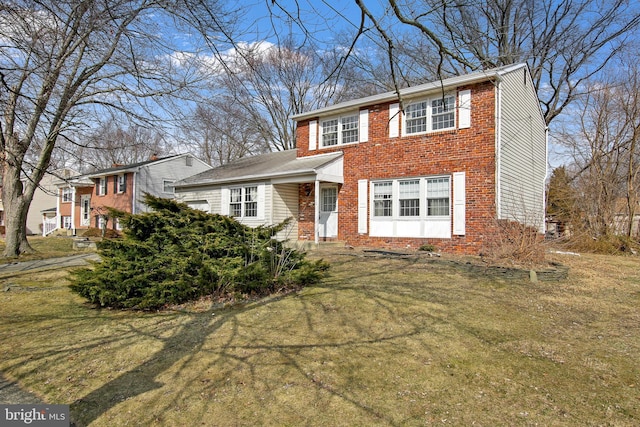 colonial house with brick siding and a front yard