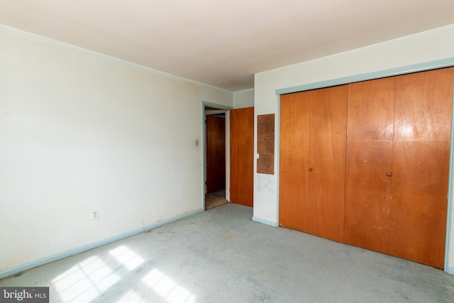 unfurnished bedroom with carpet floors and a closet