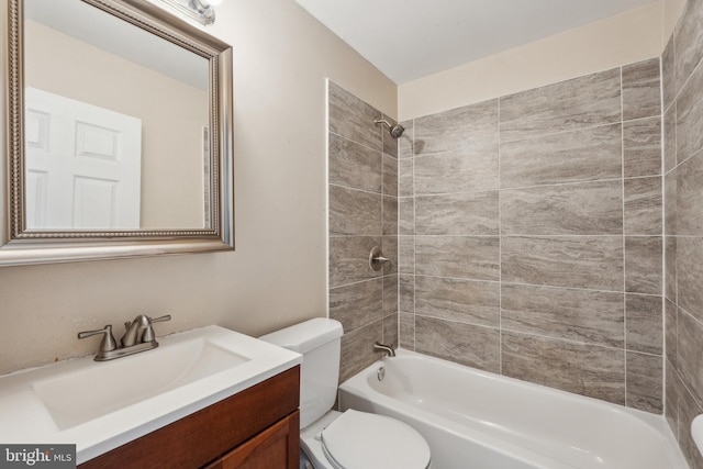 full bathroom featuring toilet, washtub / shower combination, and vanity