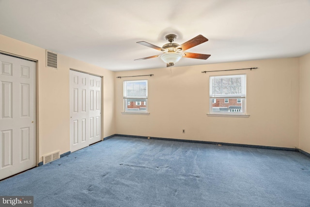 unfurnished bedroom with visible vents, baseboards, carpet, and ceiling fan