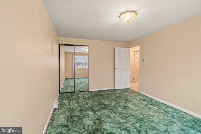 unfurnished bedroom featuring a closet, carpet floors, and baseboards