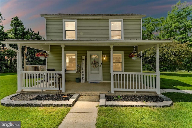 farmhouse-style home with a porch and a front yard