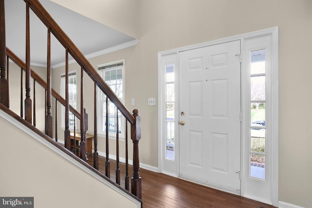 foyer entrance featuring crown molding, stairs, baseboards, and dark wood-style flooring