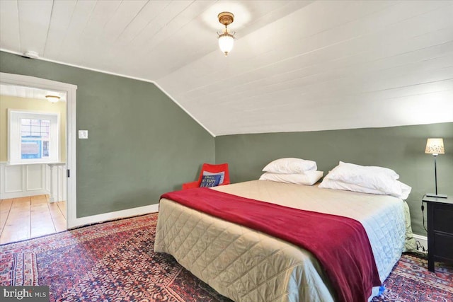 bedroom featuring baseboards, wood finished floors, wooden ceiling, and vaulted ceiling