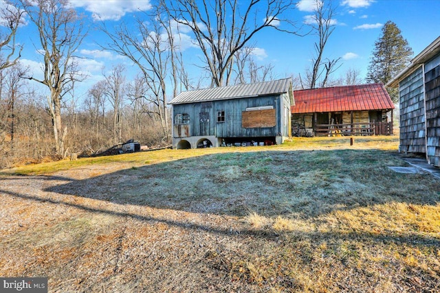 view of front of house featuring an outbuilding and metal roof