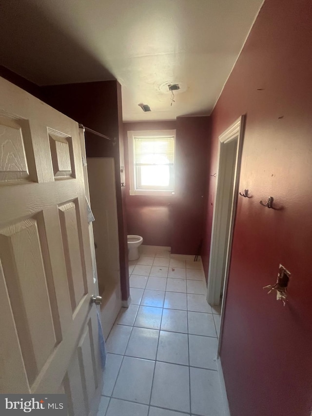 bathroom featuring tile patterned flooring and toilet