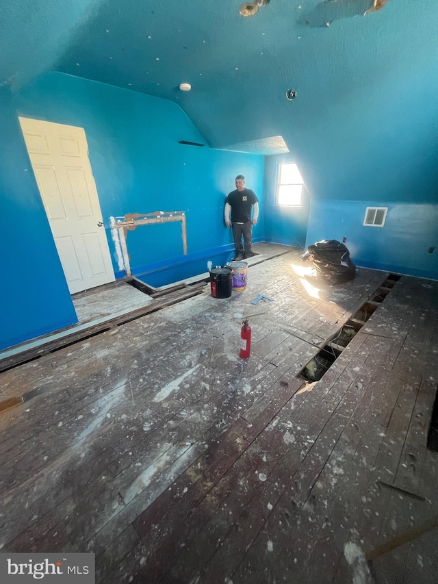 bonus room featuring vaulted ceiling and hardwood / wood-style floors