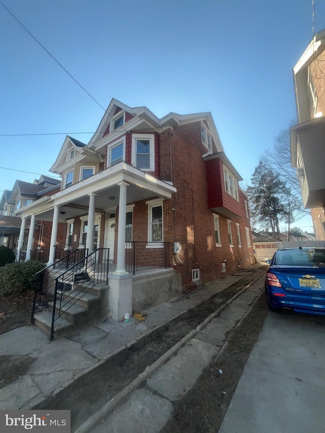 view of front of home featuring a porch and brick siding