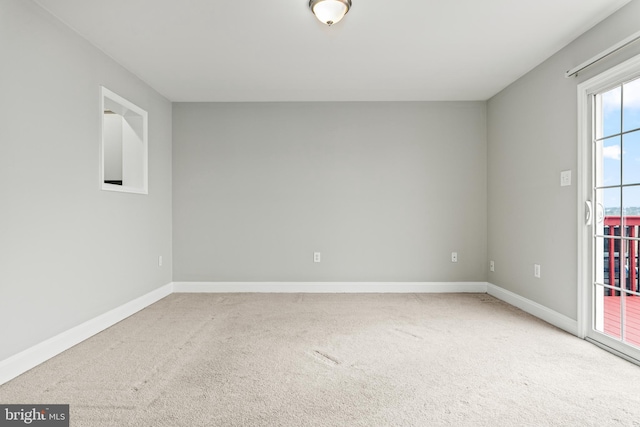 carpeted empty room with baseboards