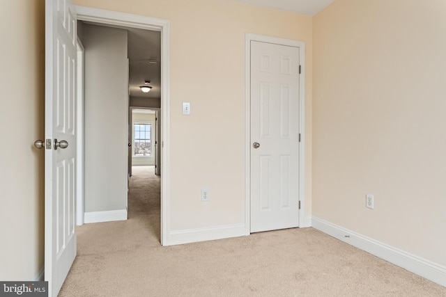 unfurnished bedroom with carpet and baseboards