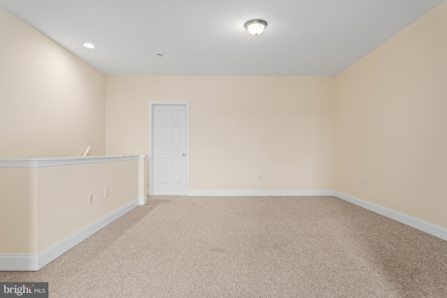 unfurnished room with recessed lighting, baseboards, and light colored carpet