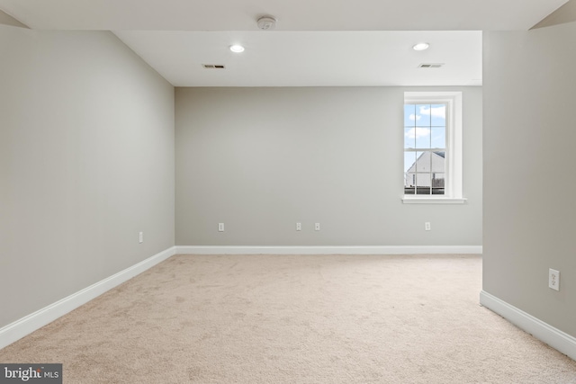 empty room featuring recessed lighting, baseboards, visible vents, and light colored carpet