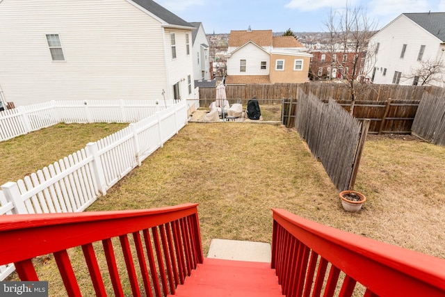 view of yard featuring a fenced backyard and a residential view