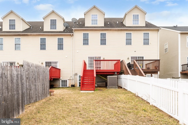 rear view of house featuring a deck, a fenced backyard, central air condition unit, stairs, and a yard