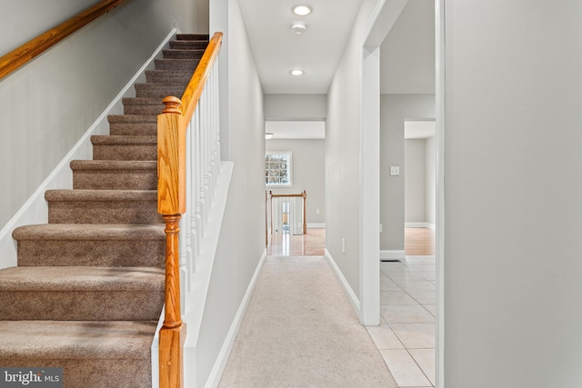 staircase with tile patterned flooring and baseboards