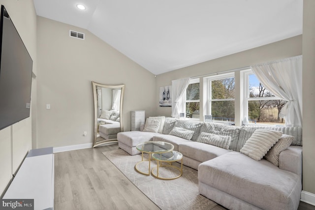 living room featuring high vaulted ceiling, recessed lighting, visible vents, baseboards, and light wood-style floors