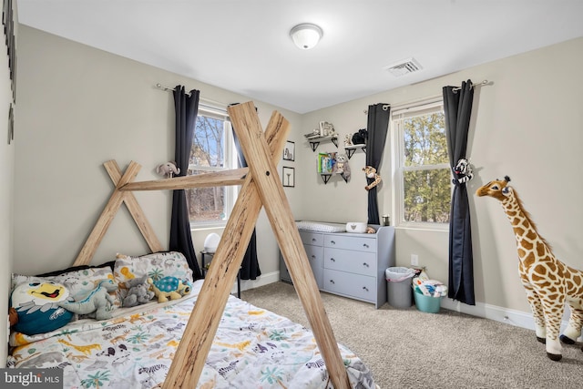 carpeted bedroom with visible vents and baseboards