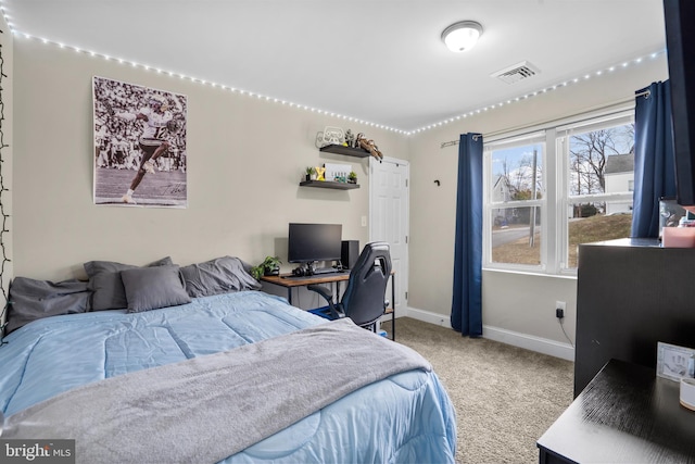 bedroom with carpet, visible vents, and baseboards