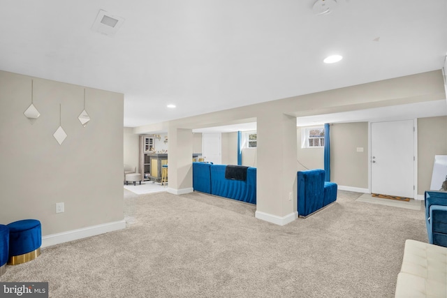 unfurnished living room with baseboards, visible vents, carpet flooring, and recessed lighting