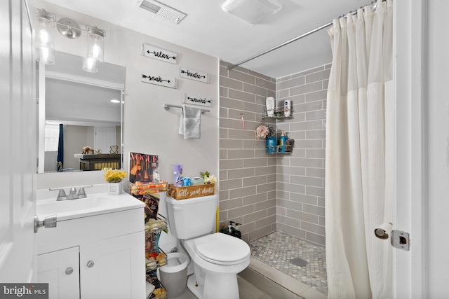 full bath with toilet, a stall shower, visible vents, and vanity