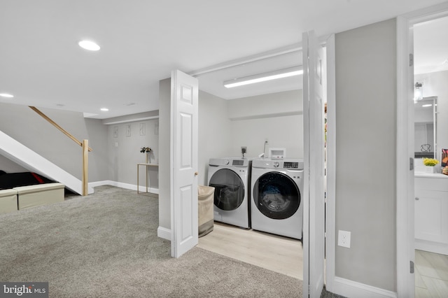 laundry room with laundry area, carpet flooring, washing machine and clothes dryer, and baseboards