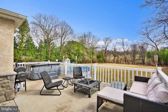 view of patio / terrace featuring a pool and an outdoor living space with a fire pit