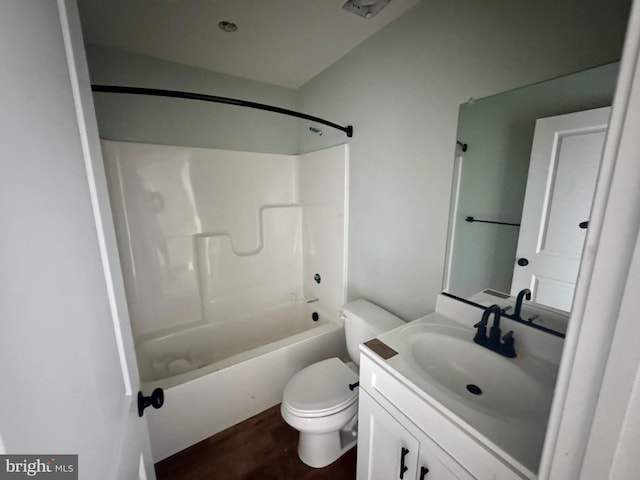 full bath with tub / shower combination, vanity, toilet, and wood finished floors