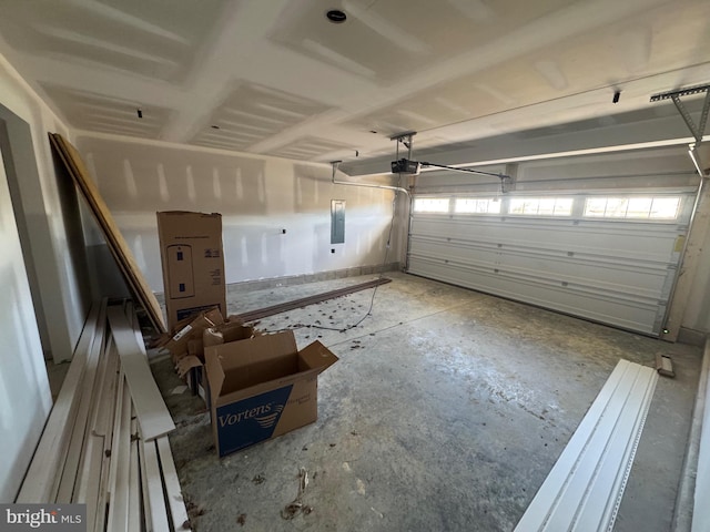 garage featuring electric panel and a garage door opener