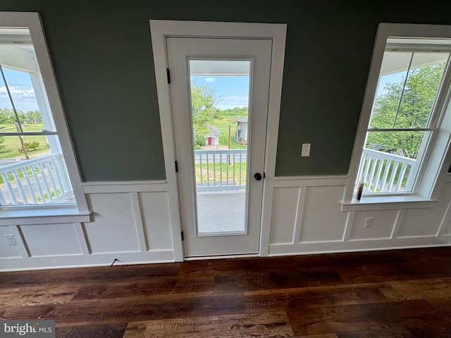 419 Kentmorr Rd, Stevensville, MD 21666 - doorway to outside featuring a decorative wall, wainscoting, dark wood-type flooring, and plenty of natural light