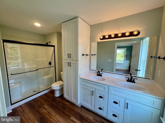 419 Kentmorr Rd, Stevensville, MD 21666 - bathroom with a stall shower, wood finished floors, toilet, and double vanity