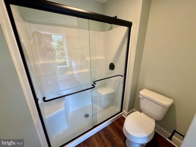 419 Kentmorr Rd, Stevensville, MD 21666 - bathroom featuring wood finished floors, toilet, a stall shower, and baseboards
