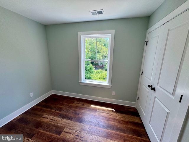 419 Kentmorr Rd, Stevensville, MD 21666 - unfurnished bedroom featuring baseboards, dark wood finished floors, and a closet