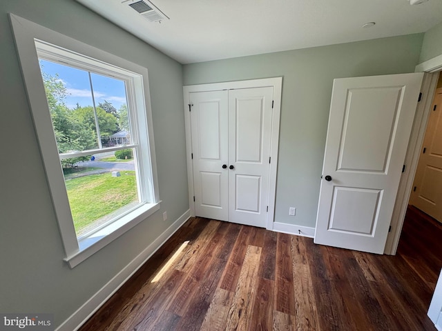 419 Kentmorr Rd, Stevensville, MD 21666 - unfurnished bedroom with dark wood-style floors, baseboards, and a closet
