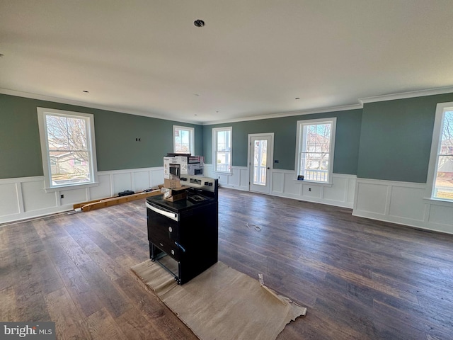 interior space featuring wainscoting, ornamental molding, dark wood finished floors, and open floor plan