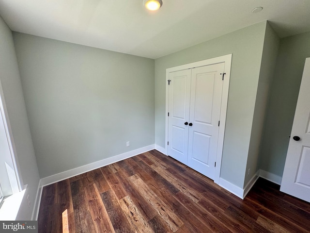 419 Kentmorr Rd, Stevensville, MD 21666 - unfurnished bedroom with dark wood-type flooring, baseboards, and a closet