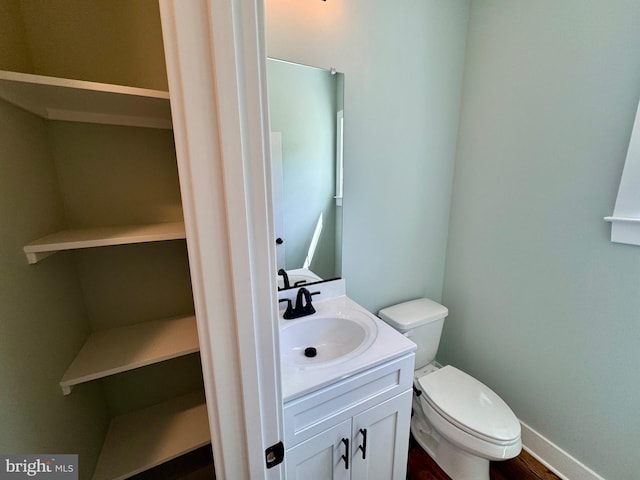 419 Kentmorr Rd, Stevensville, MD 21666 - bathroom with toilet, vanity, baseboards, and wood finished floors