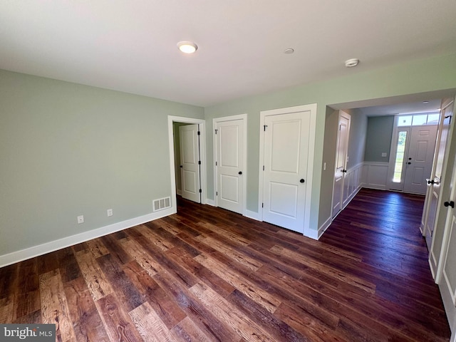 419 Kentmorr Rd, Stevensville, MD 21666 - unfurnished bedroom featuring dark wood-type flooring, two closets, and baseboards