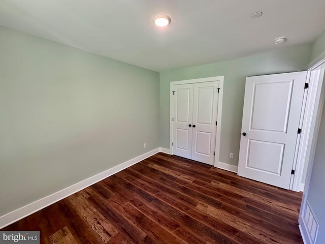 419 Kentmorr Rd, Stevensville, MD 21666 - unfurnished bedroom with dark wood finished floors, baseboards, and a closet