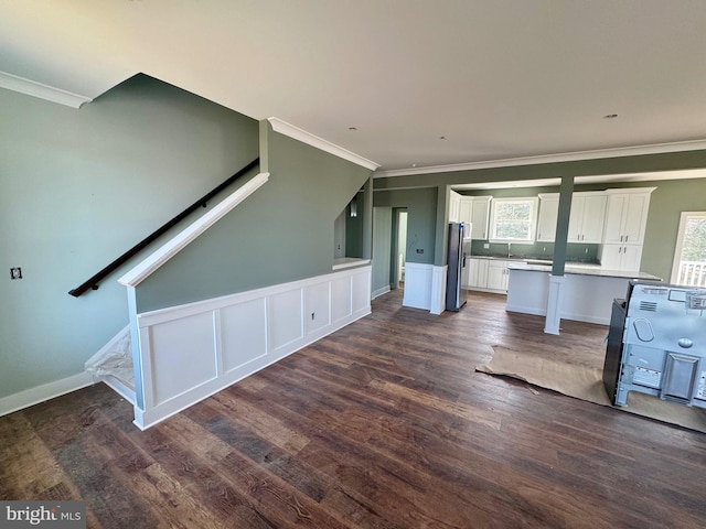 interior space with stairway, dark wood-type flooring, and ornamental molding