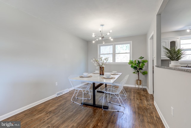 dining area featuring visible vents, plenty of natural light, baseboards, and wood finished floors