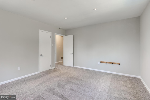 spare room featuring recessed lighting, baseboards, and carpet