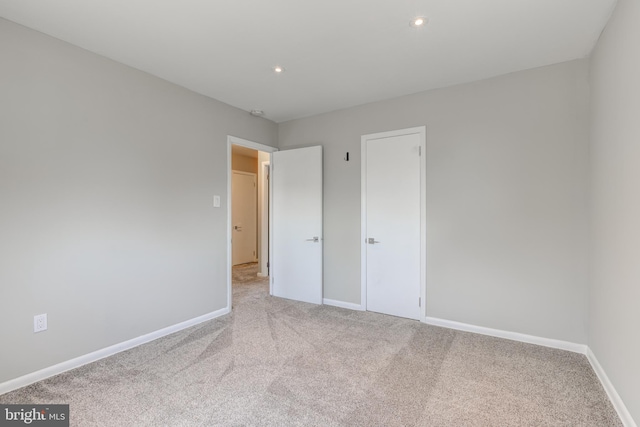 unfurnished bedroom with recessed lighting, baseboards, and carpet floors