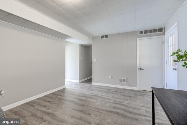 interior space featuring visible vents, baseboards, and wood finished floors