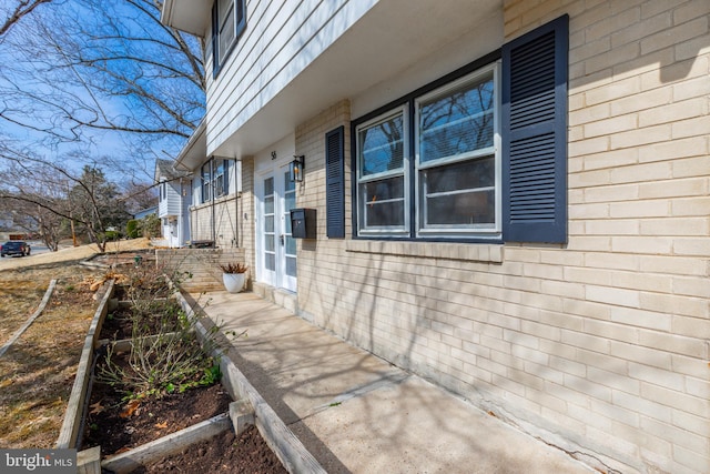 view of side of property with brick siding