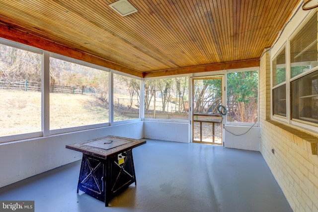 unfurnished sunroom with wooden ceiling