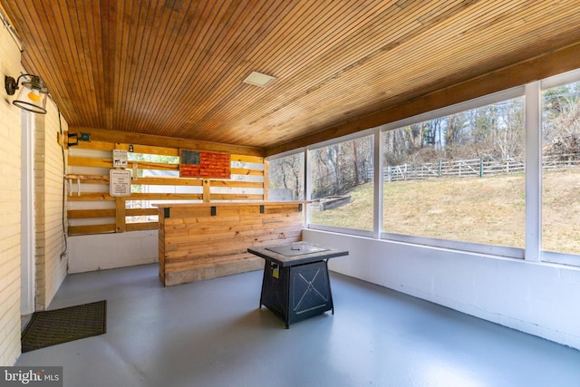 unfurnished sunroom featuring plenty of natural light and wood ceiling