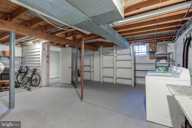 below grade area featuring independent washer and dryer and a sink