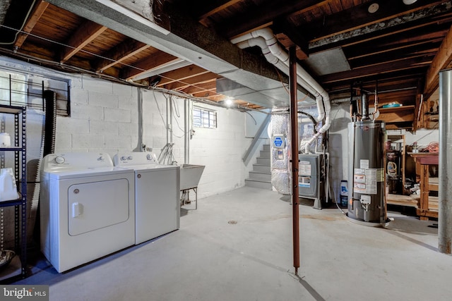 basement featuring gas water heater, stairway, heating unit, and washing machine and clothes dryer