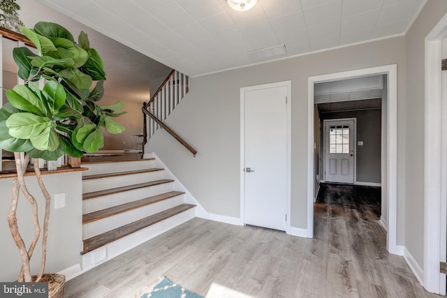 stairway featuring wood finished floors and baseboards