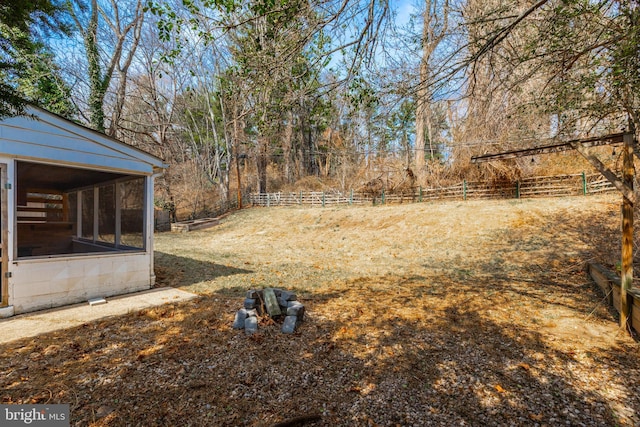 view of yard with a fenced backyard and a sunroom